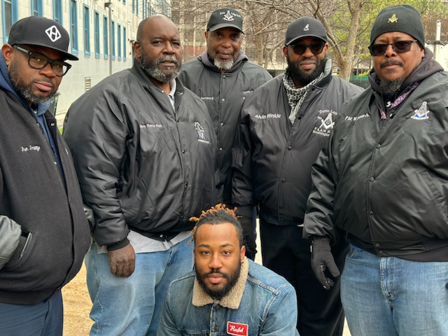 Group of men posing outdoors
